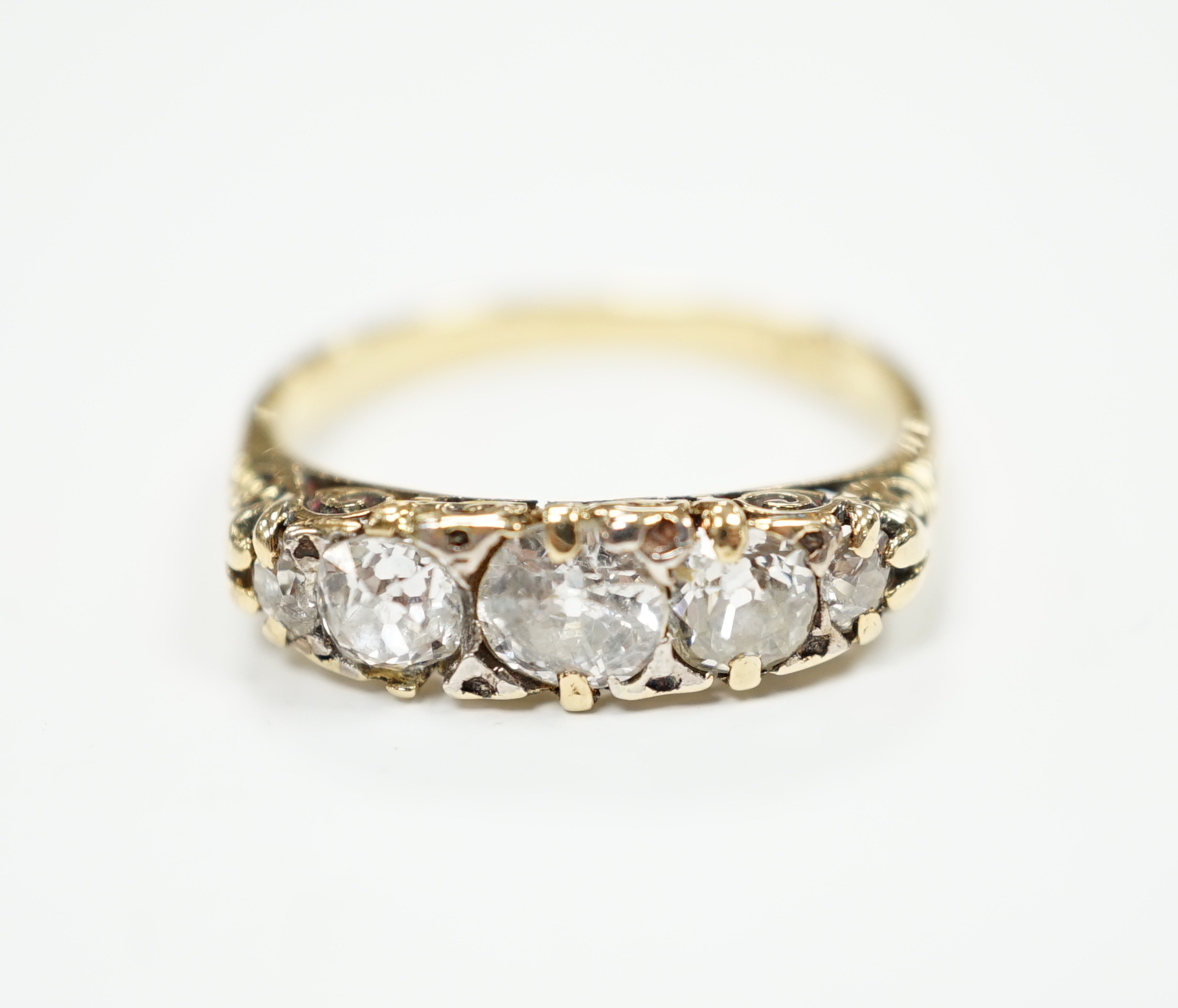 An 18ct and graduated five stone diamond set half hoop ring, size L, gross weight 2.8 grams (splits to setting).
